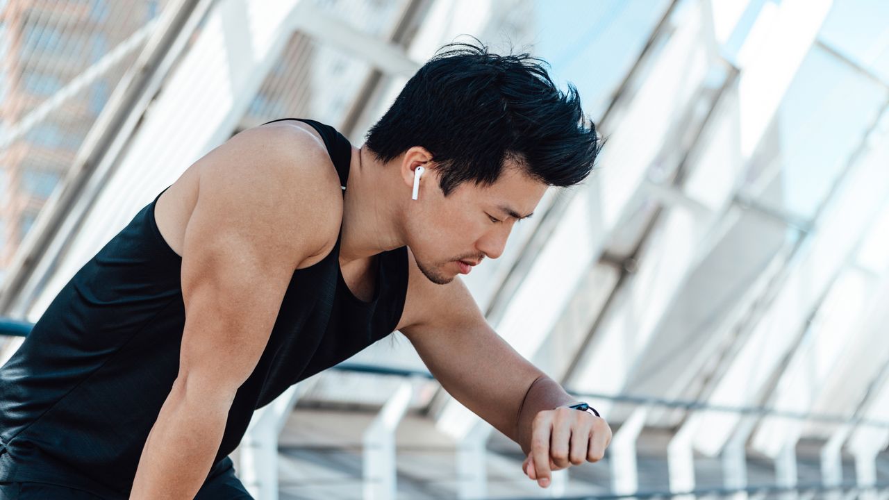 Man checking smartwatch during a run