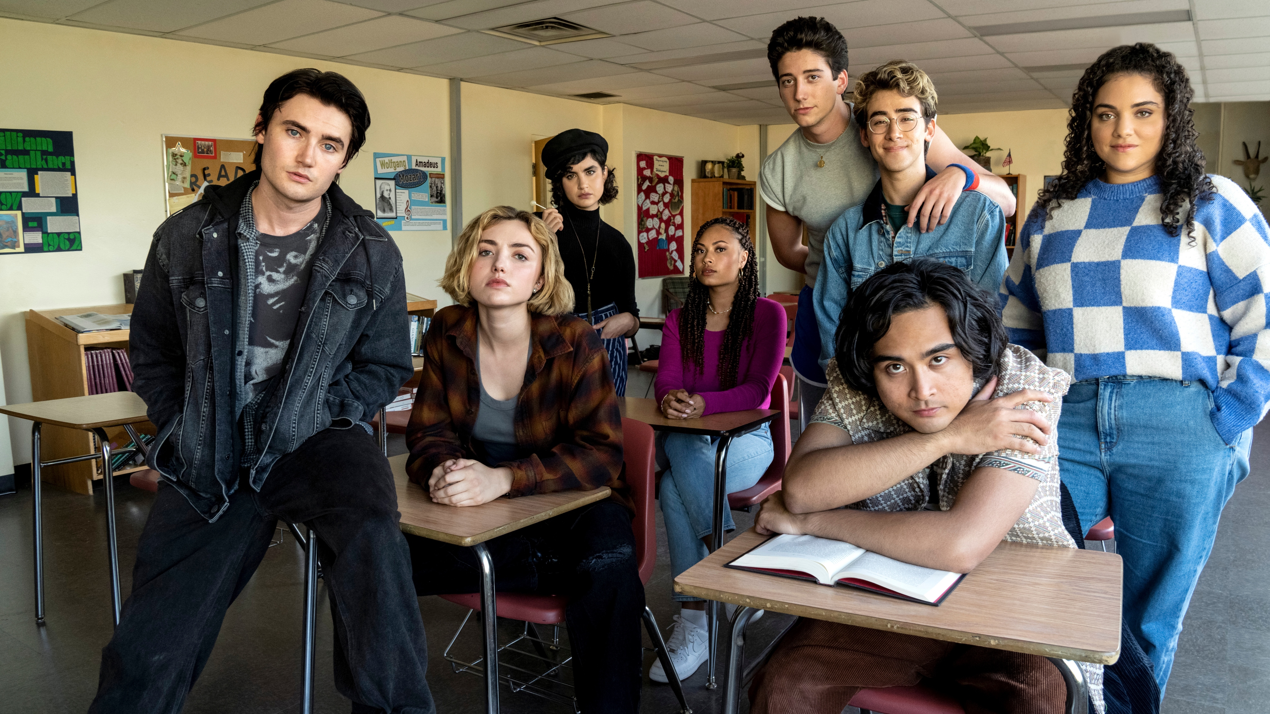 L-R: Xavier Baxter (Spencer McPherson), Maddie Nears (Peyton List), Rhonda (Sarah Yarkin), Claire Zolinski (Rainbow Wedell), Wally Clark (Milo Manheim), Charley (Nick Pugliese), Simon Elroy (Kristian Flores) and Nicole Herrera (Kiara Pichardo) in a school classroom.