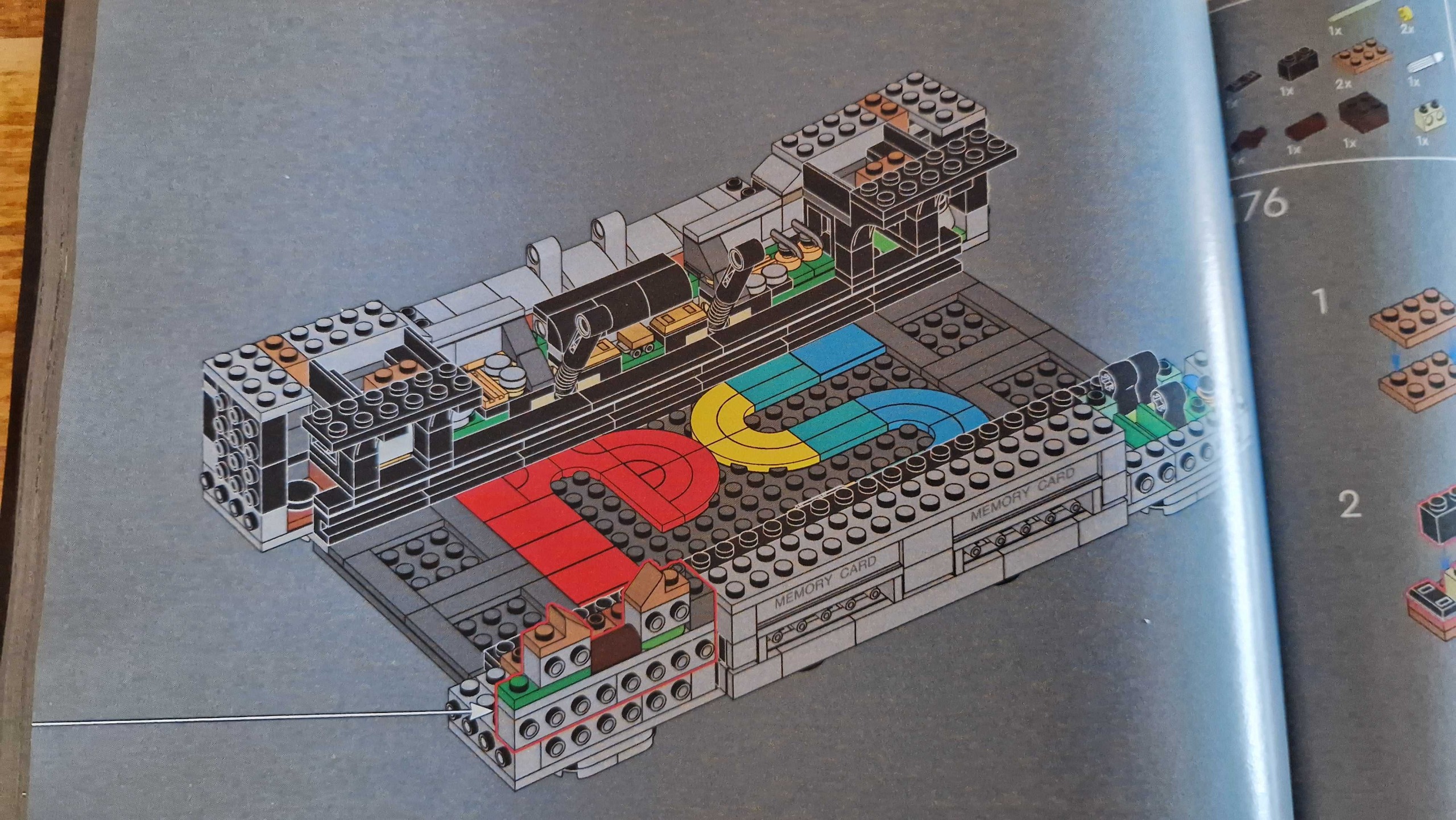 Close up on a page in the Lego PlayStation build instructions showing tiles forming the PlayStation logo