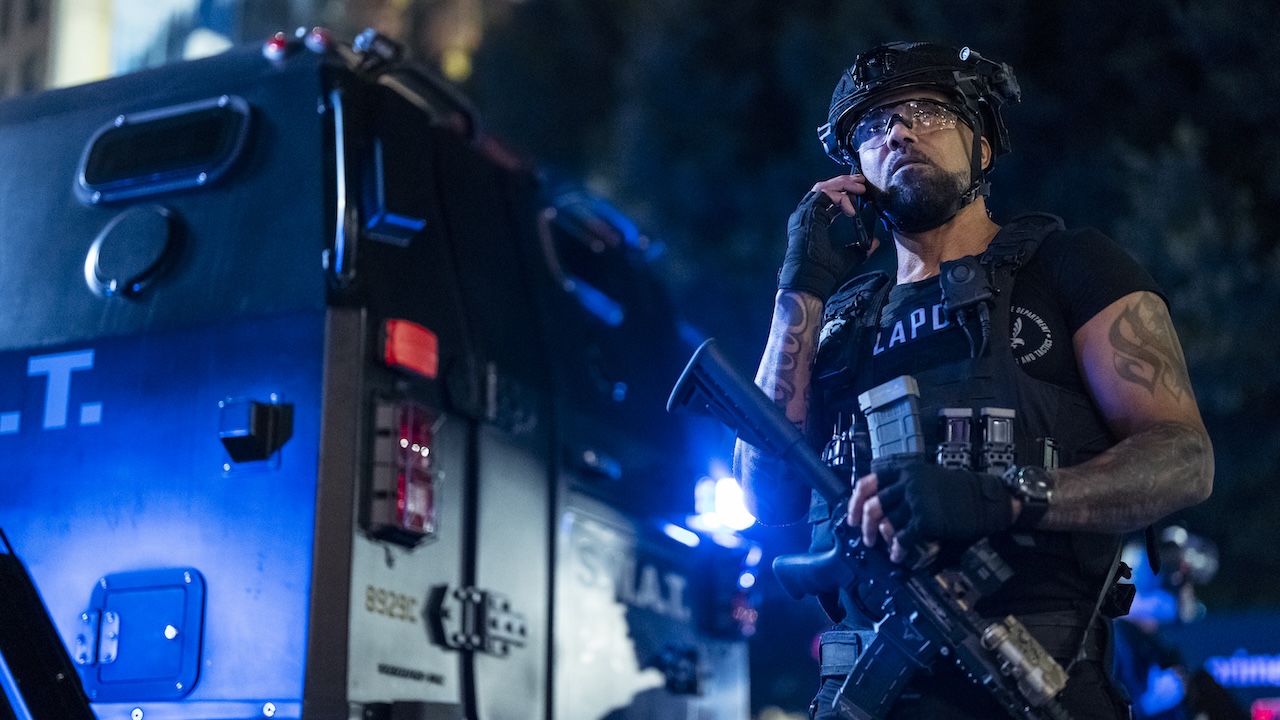 Hondo behind S.W.A.T. van on phone in S.W.A.T. Exiles Season 1