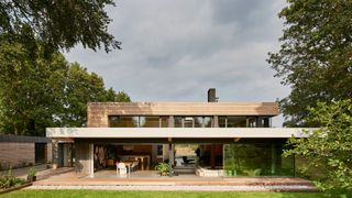 1970s house renovation with timber cladding and flat roof extension