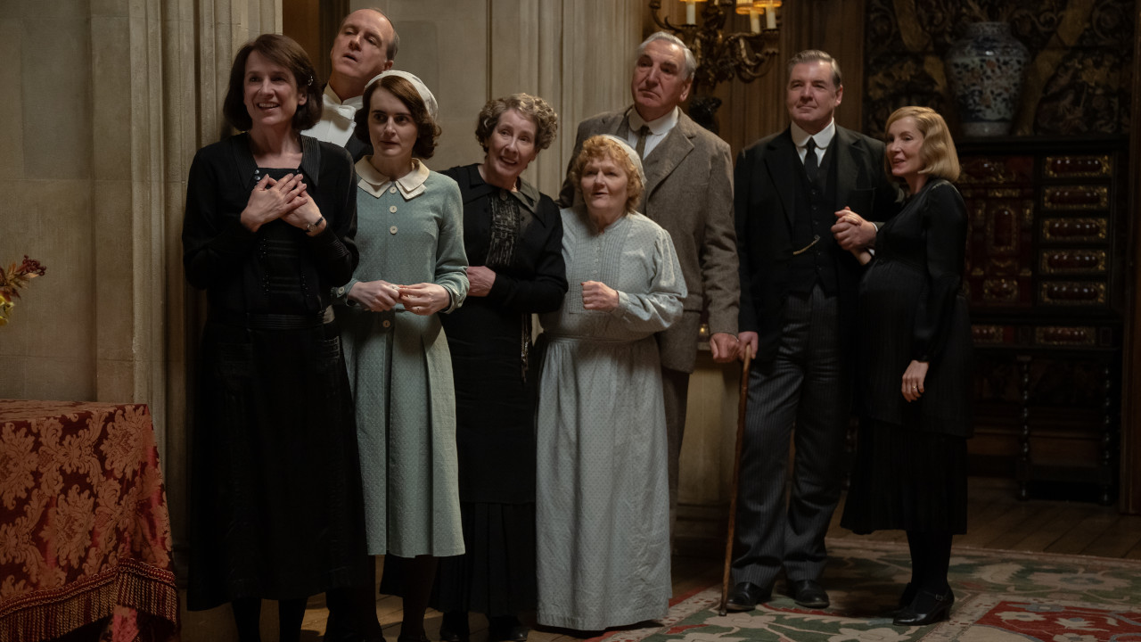 The Downton household staff watches on with anticipation and curiosity in Downton Abbey: The Grand Finale.