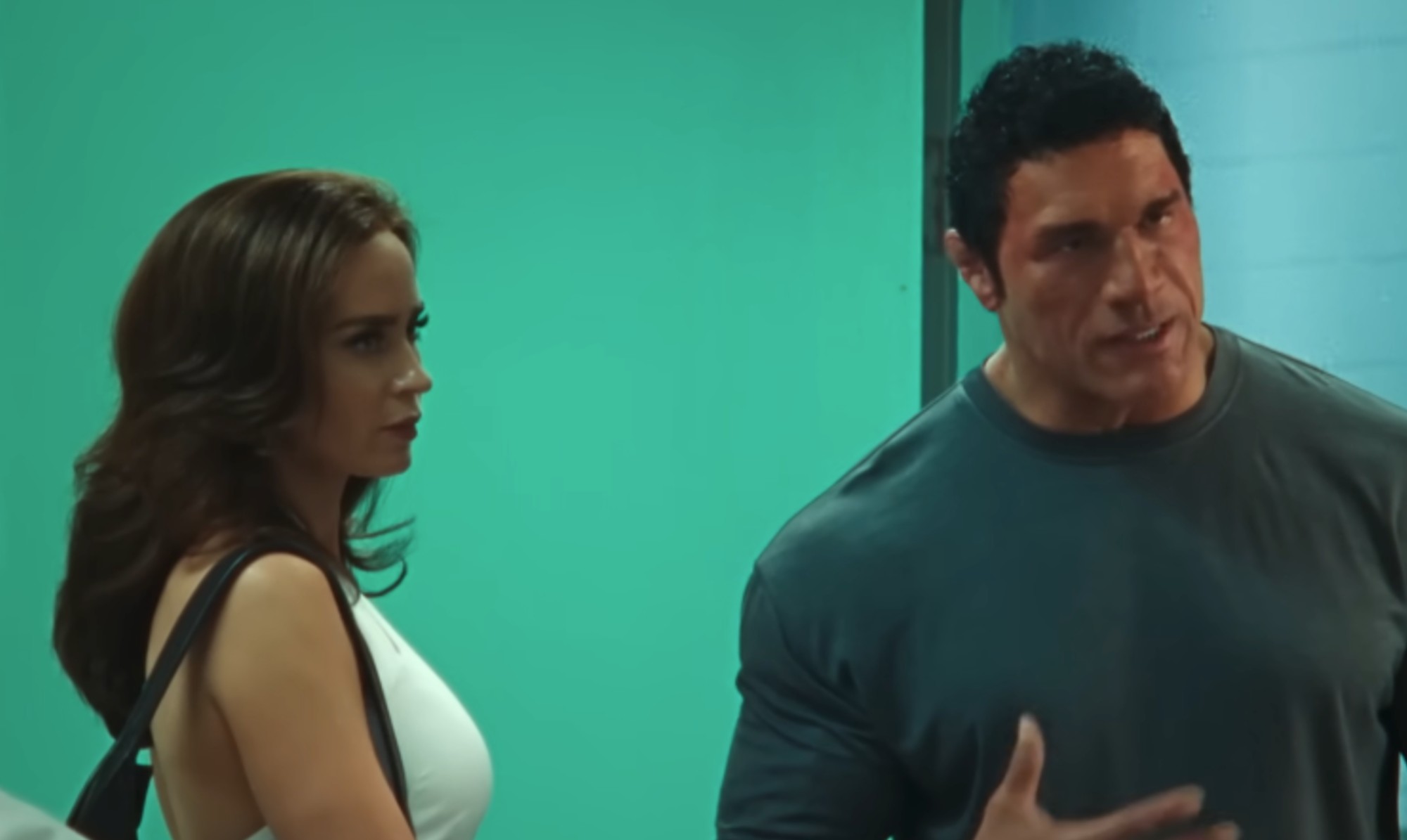 Emily Blunt on the left in white, with Dwayne Johnson on the right in blue in The Smashing Machine