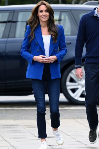 Kate Middleton wears dark blue jeans and a blue blazer as she visits SportsAid at Bisham Abbey National Sports Centre to mark World Mental Health Day on October 12, 2023 in Marlow, England.