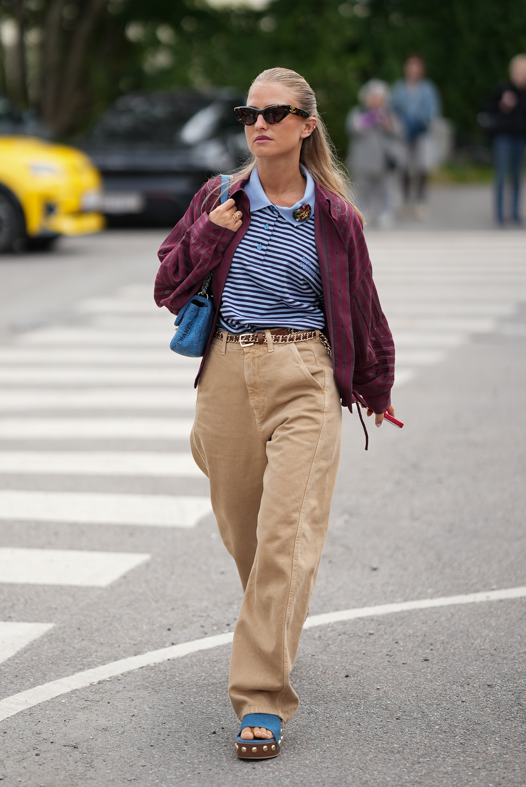 woman wearing rugby shirt, beige jeans, and sandals