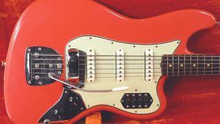 A 1962 Fender Bass VI in Shell Pink sits in its case.