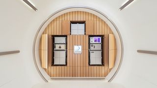 A mockup of a private space shuttle with different compartments for key areas in the overall round structure