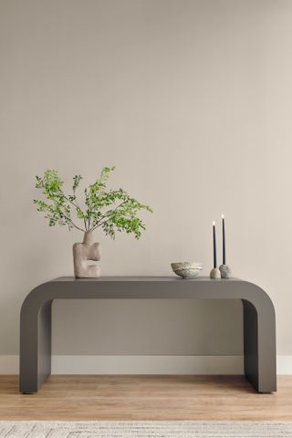 Gray console table against neutral warm gray wall