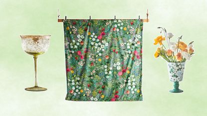 Three new Anthropologie homeware pieces including a green vase, green wine glass, and green floral bedding on a green gradient