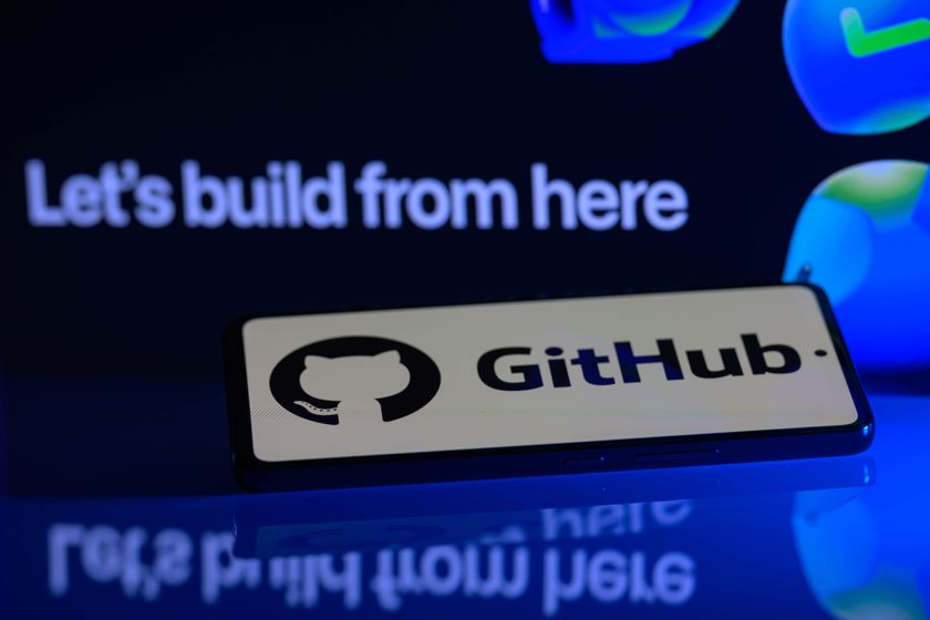 The Github Logo on a phone in front of the words "Let's build from here"