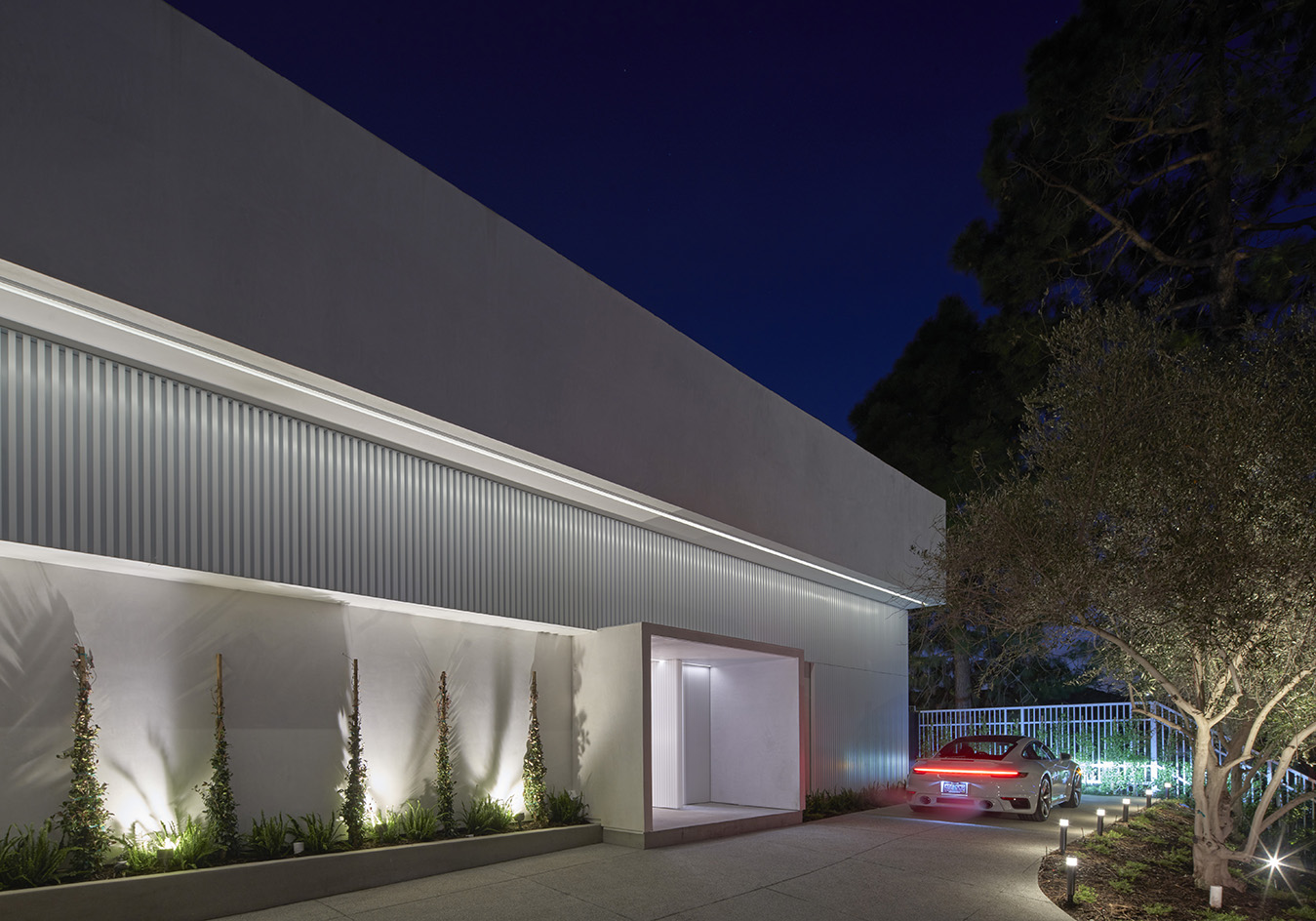 nighttime shot of white house and colour lighting Oceanus House by Pierre de Angelis