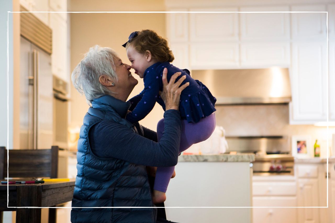 Grandmother playing with granddaughter while sitting