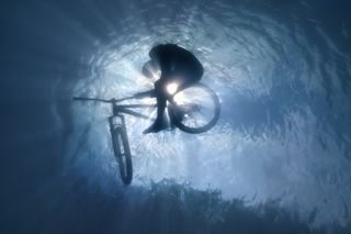 A photograph by Volodya Voronin of a BMX rider submerged in water