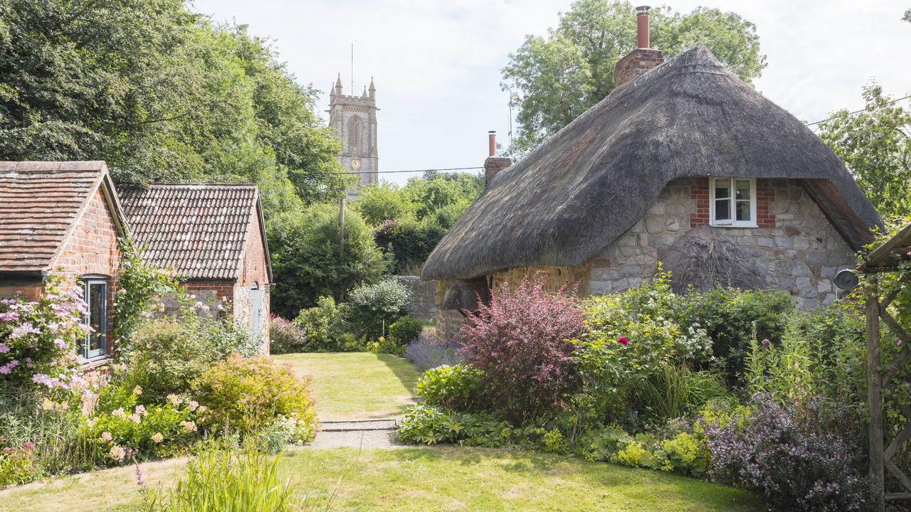 thatched cottage with village church