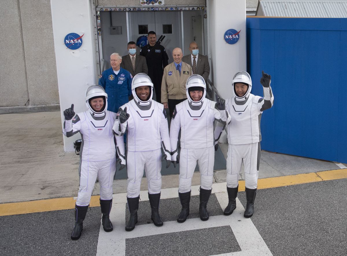 NASA&#039;s Crew-1 astronauts pose for a photo as they prepare to head to Pad 39A for their SpaceX Crew Dragon launch on Nov. 15, 2020. They are (from left): NASA astronauts Shannon Walker, Victor Glover, Mike Hopkins and Soichi Noguchi with the Japan Aerospace Exploration Agency.