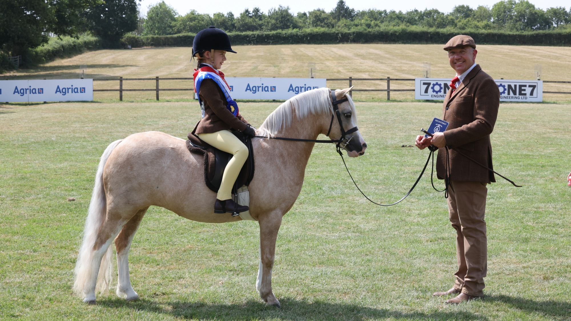 Palomino Welsh section A Glyncoch Honey Pot and Zara Constable stand for a photo at the RIHS with Zara's father Simon Constable holding them. 