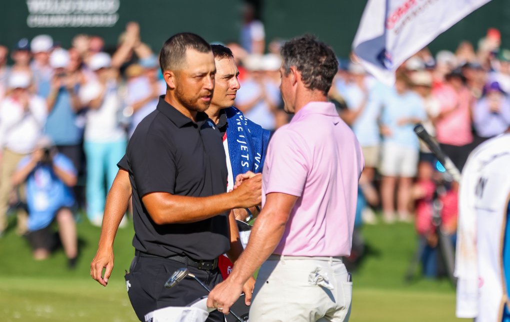 Xander Schauffele and Rory McIlroy shake hands on the 18th green at the 2024 Wells Fargo Championship