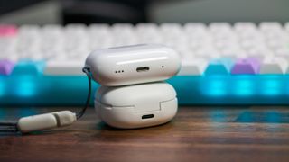 Galaxy Buds 2 Pro and AirPods Pro 2 stacked charging cases showing ports