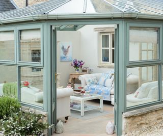 green framed conservatory showing inside as sitting room