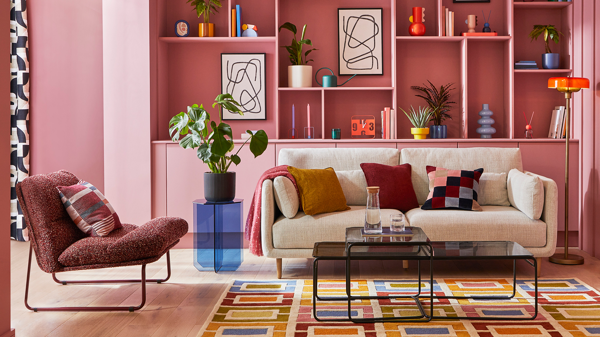 Pink living room with retro furnishings to highlight an autumn winter home decor trend 2025