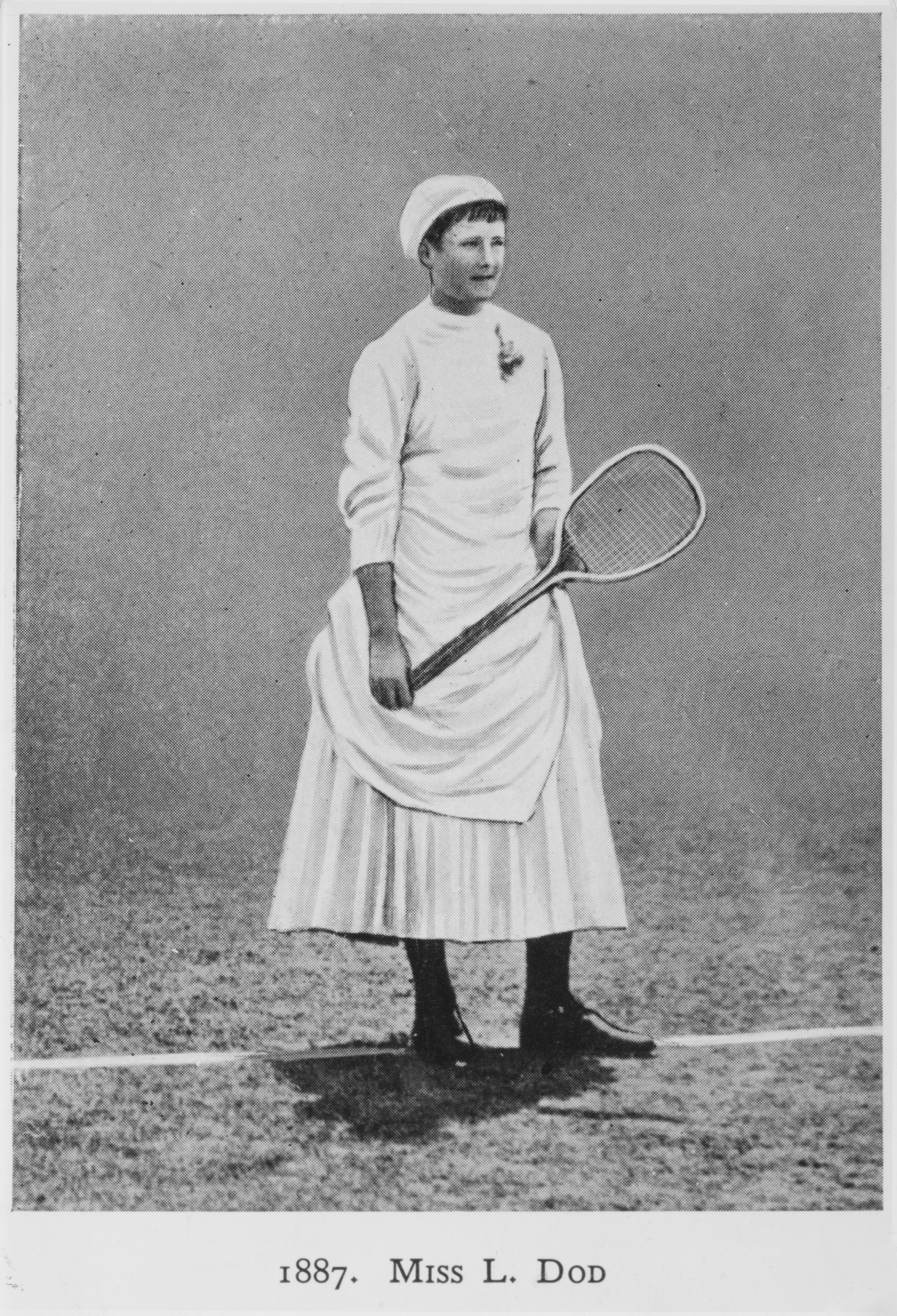 Black and white photograph of Lottie Dod posing with her wooden tennis racket