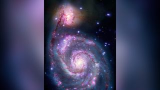 An artist's illustration of a neutron star around a black hole in the M51 Whirlpool Galaxy that may host an exoplanet.
