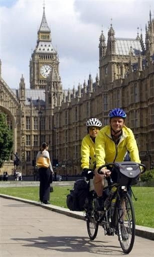 Jane Tomlinson and her brother Luke Goward pedal past the Houses of Parliament in London June 2, 2004 after their arrival as part of a 35-day bike ride from Rome to Leeds.