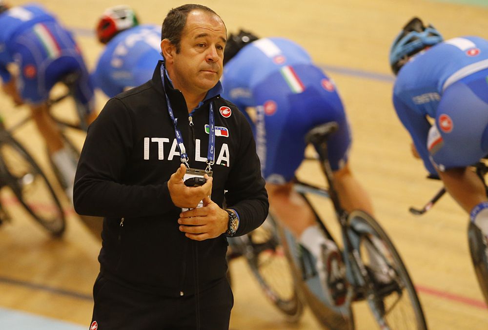 Marco Villa timing the Italian team pursuit squad during warm ups