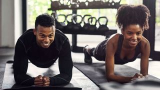 Woman and man doing low plank.