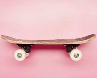 A skateboard on pink background
