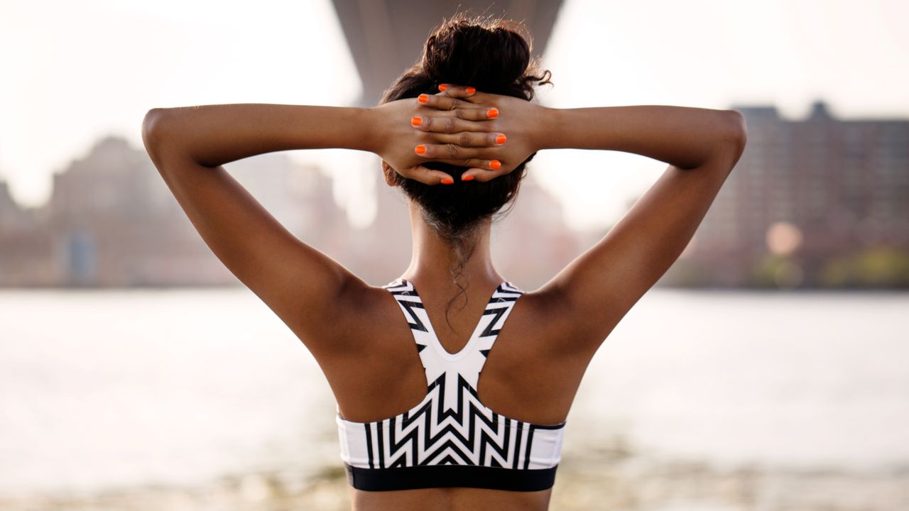 Woman stretching during a workout, which workout burns the most calories