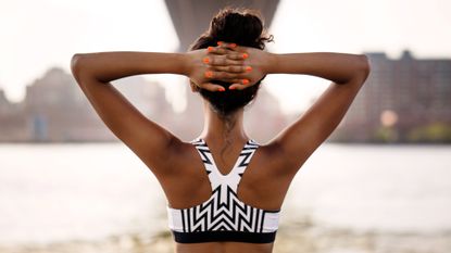 Woman stretching during a workout, which workout burns the most calories