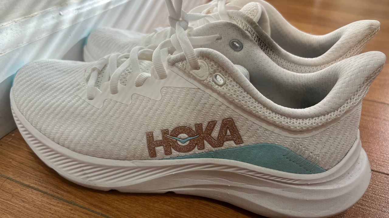 A pair of Hoka Solimar shoes on a wooden floor