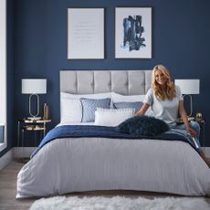 blue wall bedroom with white and blue colour cushions