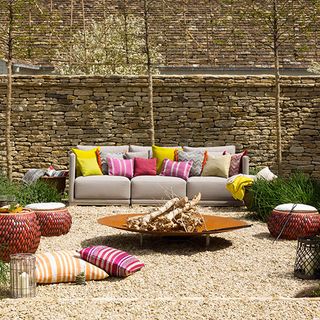 fire pit garden with bricked wall and sofa set with cushions