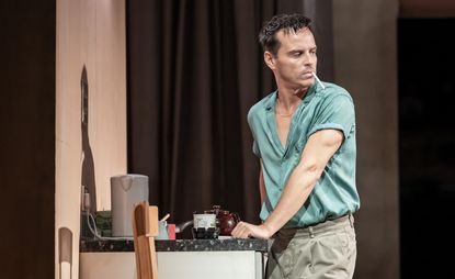 Actor Andrew Scott amid Vanya set design, at National Theatre, on stage in blue shirt