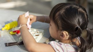 A girl wearing a hearing aid.