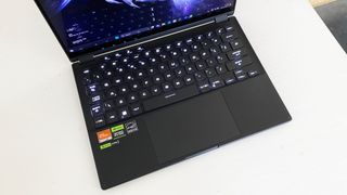 Asus ROG Flow X13 laptop keyboard on a white desk