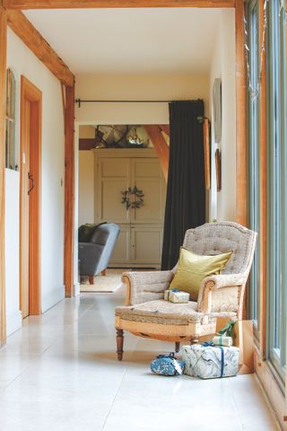 long hallway in oak frame house with armchair