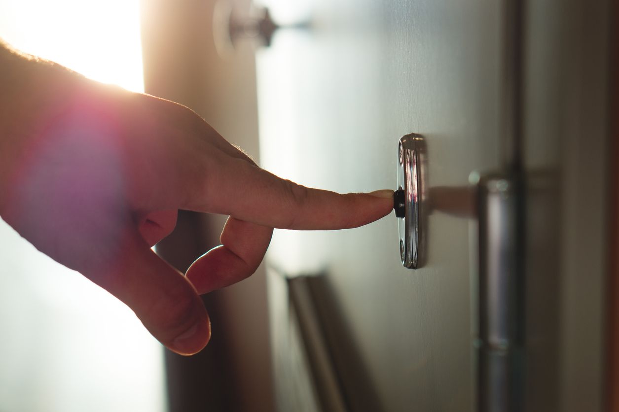 A person ringing a doorbell.