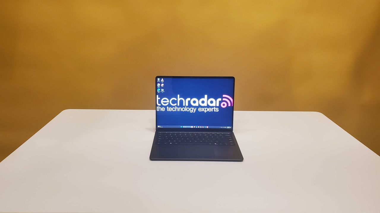 black laptop on white table