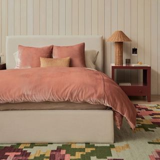 Velvet duvet cover in salmon pink on bed in bedroom in neutral colors