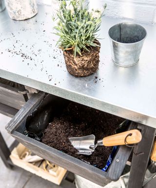 potting table with pots and tools