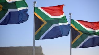 South African national flags flying at the Waterfront with Table Mountain in the background