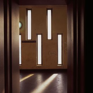 Vertical slits in the lift and staircase volume bring soft light into the circulation areas.