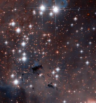 This Hubble Space Telescope image shows a section of the Eagle Nebula, specifically NGC 6611, an open star cluster that formed about 5.5 million years ago, and lies approximately 6500 light-years from Earth. It is a young cluster containing many hot, blue