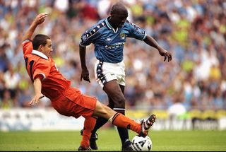 Shaun Goater of Manchester City is challenged by Jason Blunt of Blackpool during the Nationwide Division Two match at Maine Road in Manchester, England. City won 3-0. \ Mandatory Credit: Ross Kinnaird /Allsport