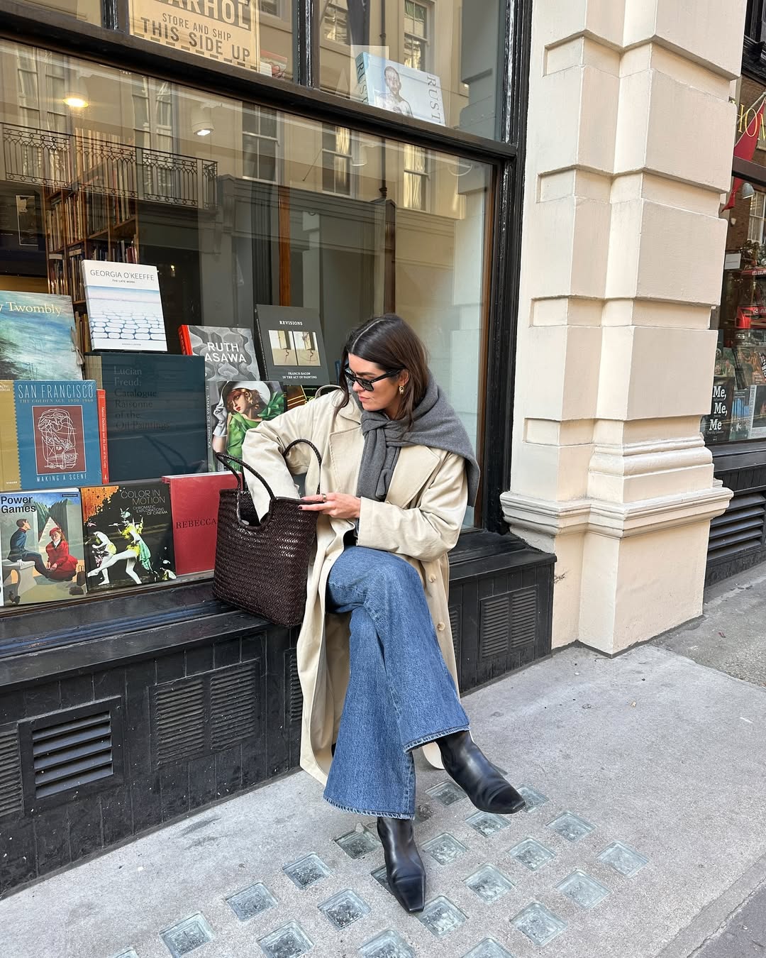Anna wearing a trench, ankle boots and flare jeans