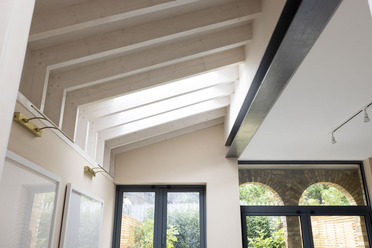 A ceiling with rooflights and exposed rafters