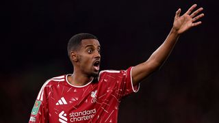 Alexander Isak raises his hand in frustration during a match for Liverpool